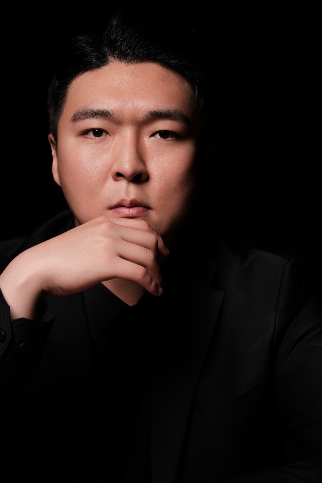 Stephano Park — close-up portrait with one hand resting beneath the chin