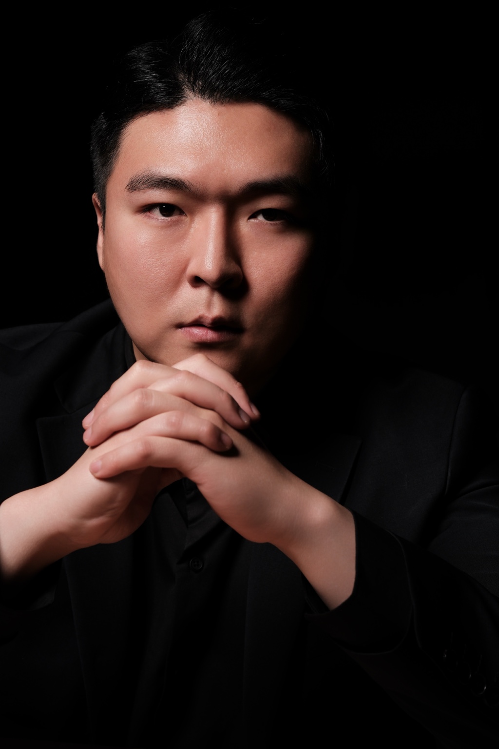 Stephano Park — portrait with clasped hands beneath the chin